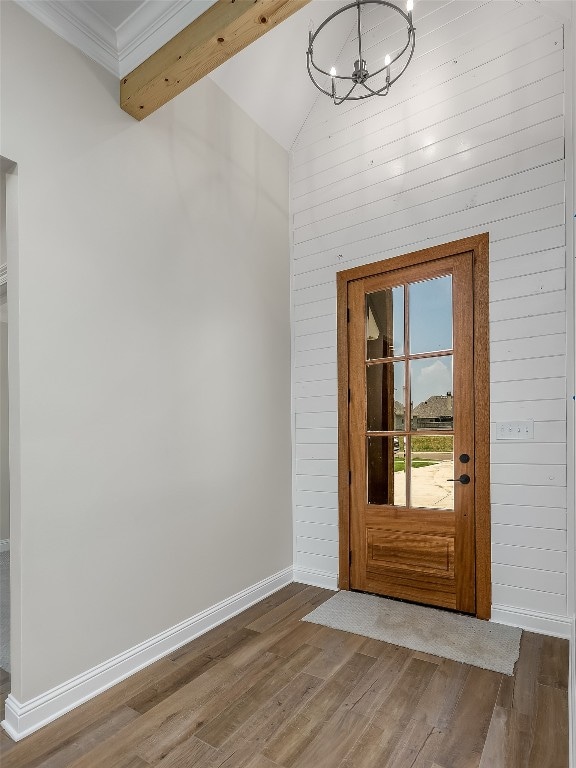 entryway with a notable chandelier, vaulted ceiling with beams, and dark hardwood / wood-style flooring