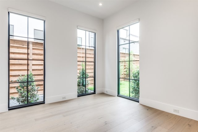 empty room with light hardwood / wood-style floors