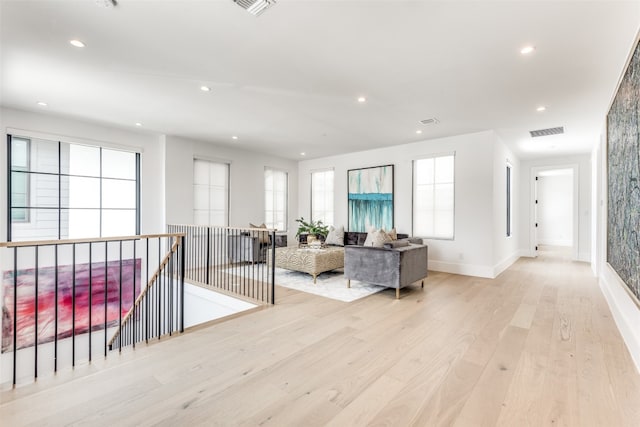 corridor featuring light hardwood / wood-style floors and a wealth of natural light