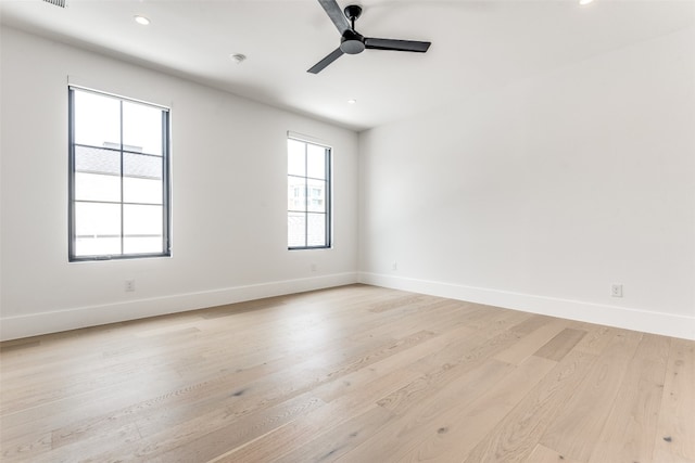 unfurnished room featuring ceiling fan and light wood-type flooring