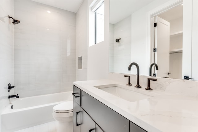 full bathroom featuring toilet, vanity, and tiled shower / bath