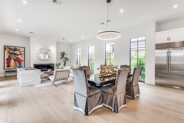 dining space with light hardwood / wood-style flooring