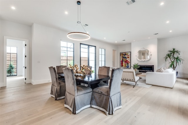 dining space with light hardwood / wood-style floors