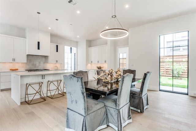 dining area featuring plenty of natural light and light hardwood / wood-style flooring