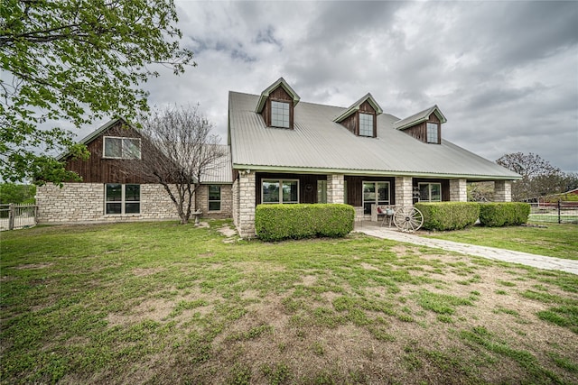 cape cod house featuring a front yard