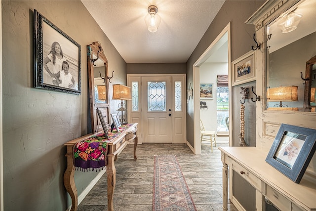 foyer with a textured ceiling and hardwood / wood-style flooring