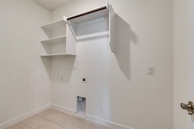 laundry area featuring electric dryer hookup, light tile flooring, and gas dryer hookup