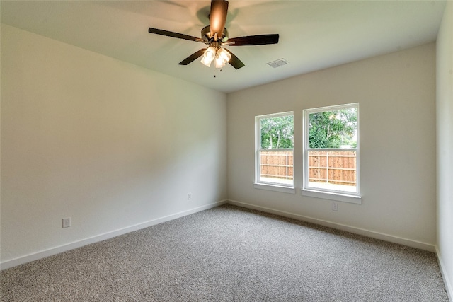 carpeted empty room featuring ceiling fan