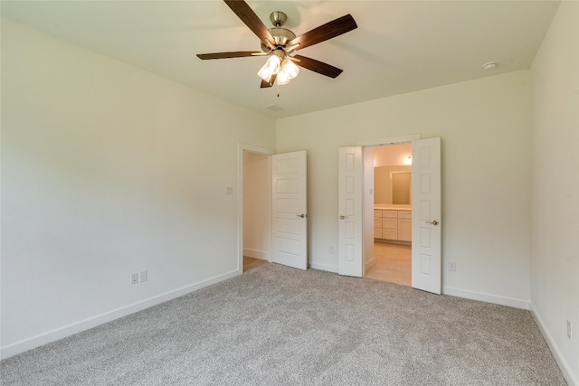 unfurnished bedroom with light colored carpet and ceiling fan