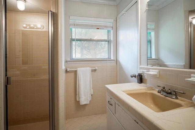 bathroom featuring vanity, an enclosed shower, and tasteful backsplash