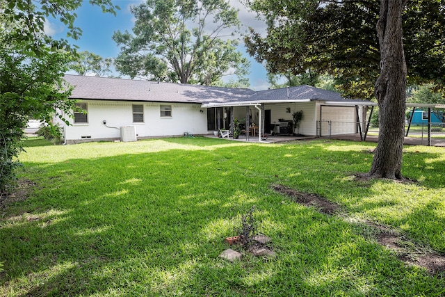 rear view of house featuring a yard and a patio