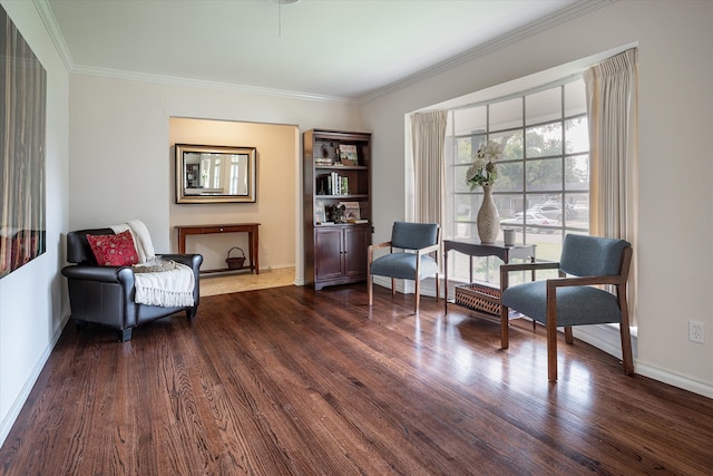 sitting room with dark hardwood / wood-style floors and crown molding