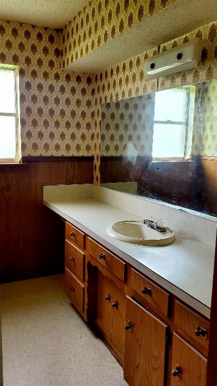 bathroom featuring a textured ceiling and vanity