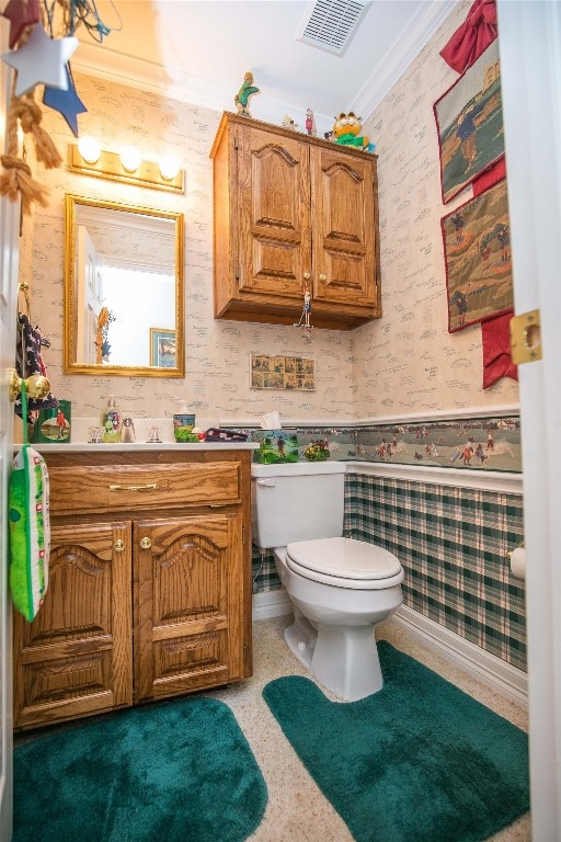 bathroom with crown molding, toilet, and large vanity