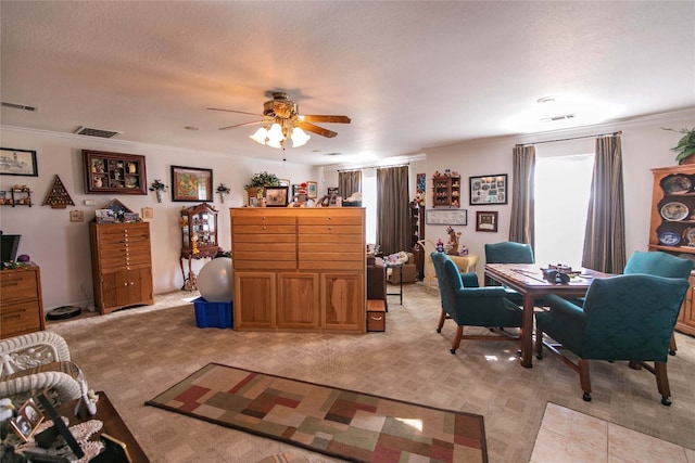 living room featuring crown molding and ceiling fan