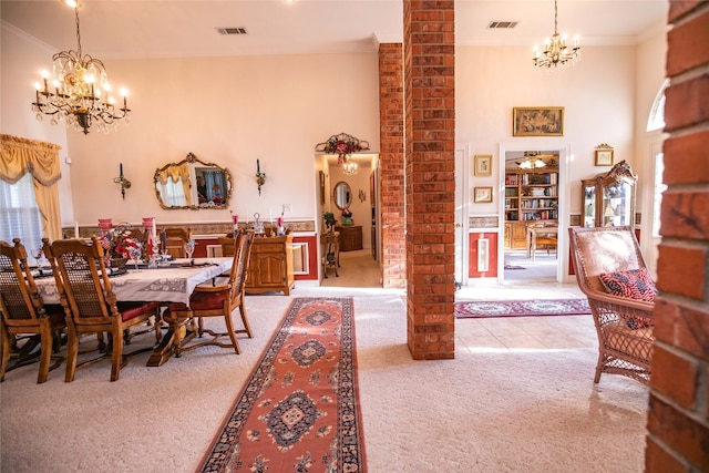 dining space with an inviting chandelier, brick wall, and light colored carpet