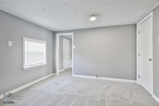 carpeted empty room with ornamental molding