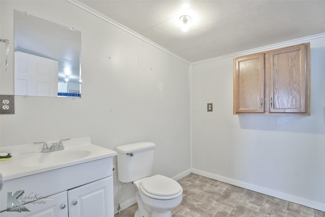 bathroom featuring toilet, vanity, and ornamental molding