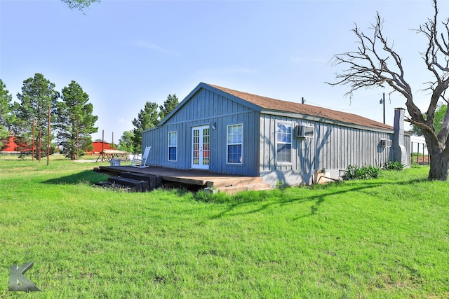 rear view of property with a lawn and a deck