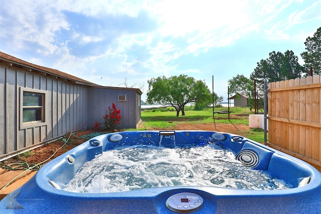 view of swimming pool featuring a hot tub