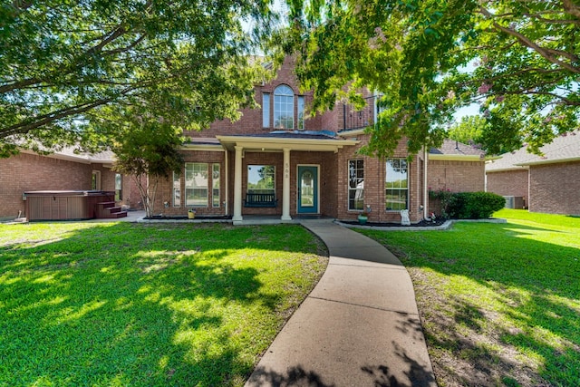 view of front of home featuring a front lawn and a hot tub