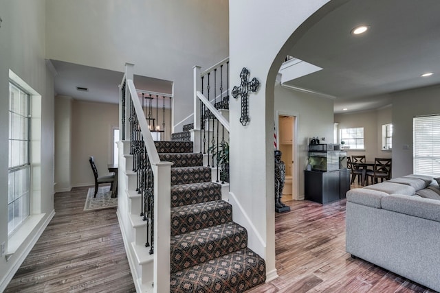 stairs featuring hardwood / wood-style floors