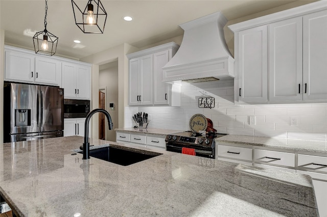 kitchen with tasteful backsplash, white cabinets, electric stove, stainless steel fridge, and premium range hood