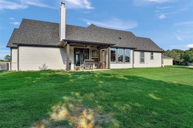 back of property featuring a patio, ceiling fan, and a lawn