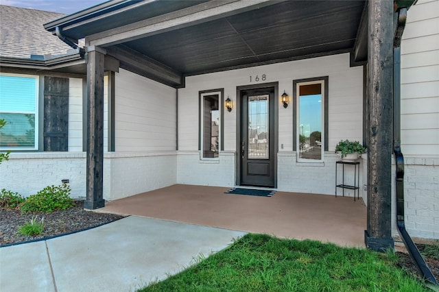 view of exterior entry featuring a porch