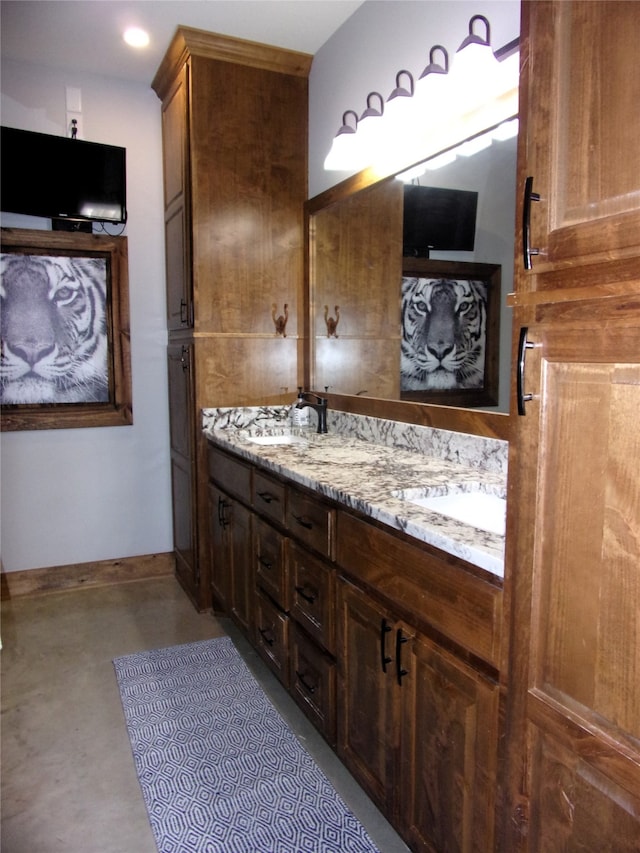 bathroom featuring vanity and concrete floors