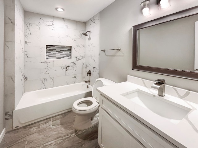 full bathroom with tiled shower / bath, toilet, vanity with extensive cabinet space, and tile floors