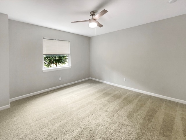 carpeted empty room featuring ceiling fan