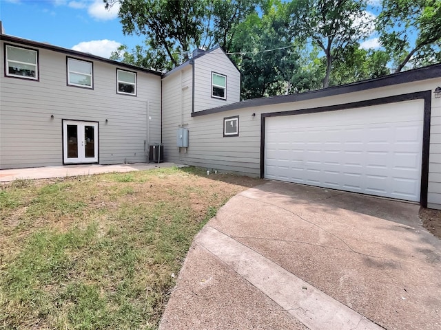 exterior space with central AC, french doors, and a yard