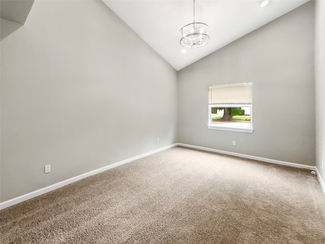 carpeted empty room featuring lofted ceiling and an inviting chandelier