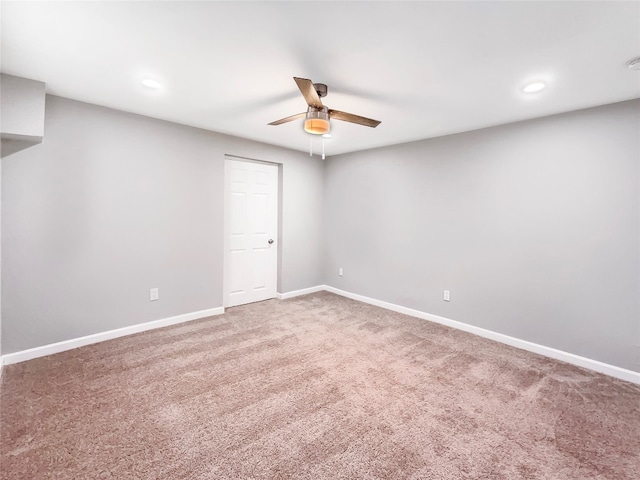 spare room featuring carpet flooring and ceiling fan