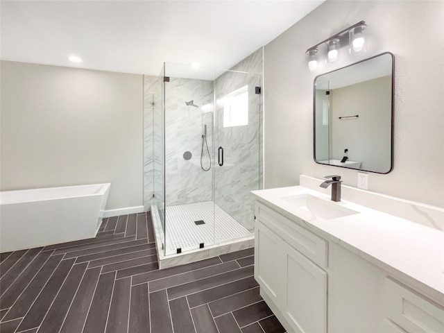 bathroom with tile floors, vanity, and independent shower and bath