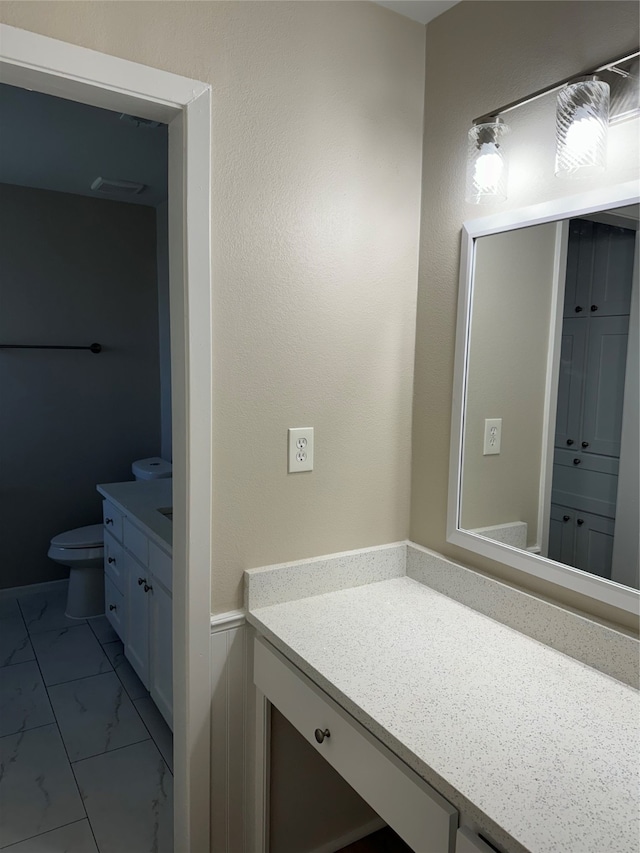 bathroom with vanity and toilet