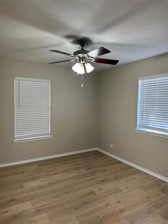 spare room with light hardwood / wood-style flooring and ceiling fan