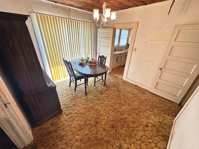 dining space featuring a notable chandelier, dark colored carpet, and wood ceiling