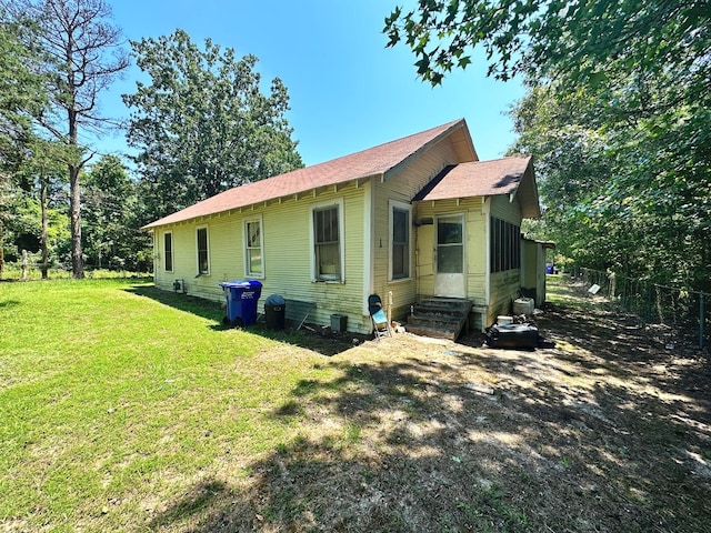 view of side of home with a yard