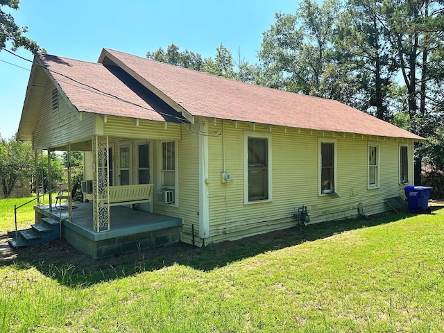 back of property with a yard