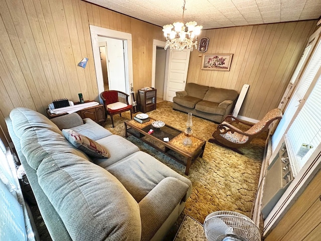 carpeted living room with wooden walls and a notable chandelier