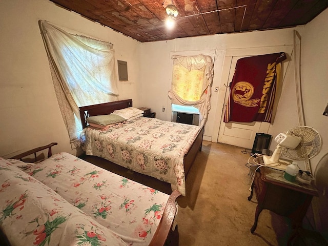 bedroom with wood ceiling and dark carpet