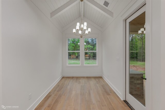 unfurnished dining area with vaulted ceiling with beams, a notable chandelier, and light hardwood / wood-style floors