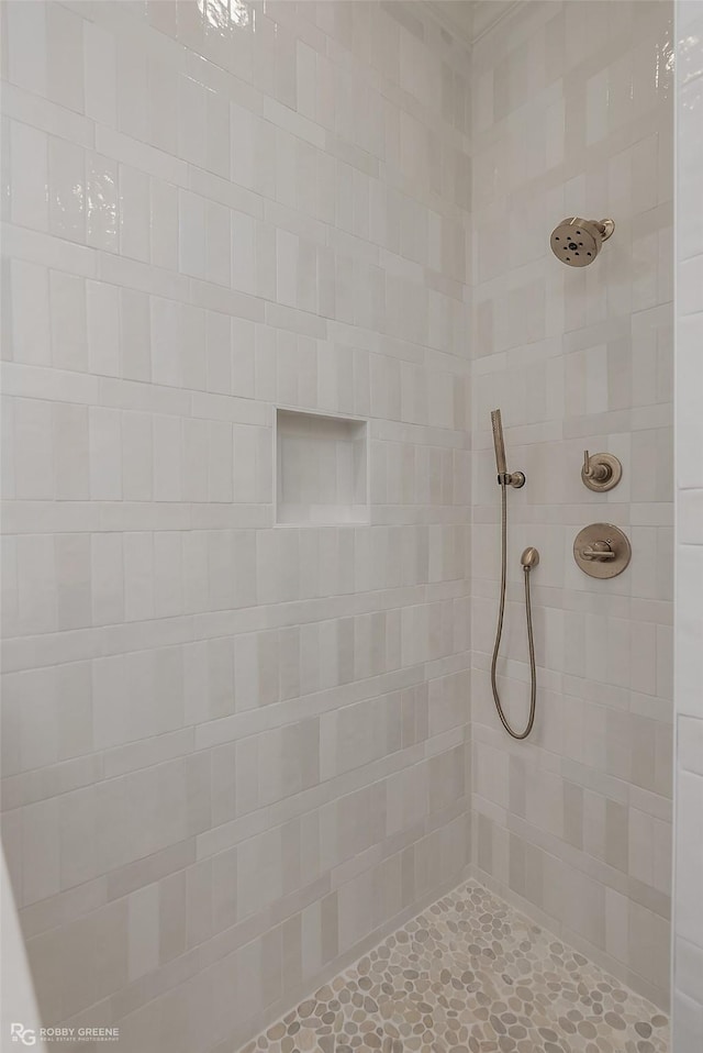 bathroom with a tile shower