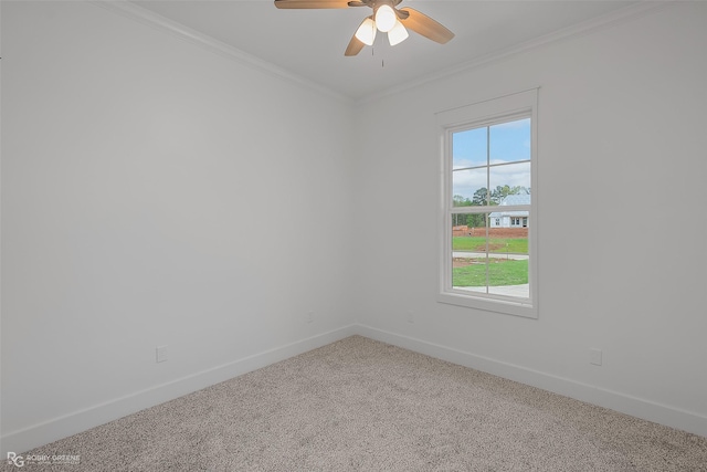 empty room with ceiling fan, ornamental molding, and carpet floors