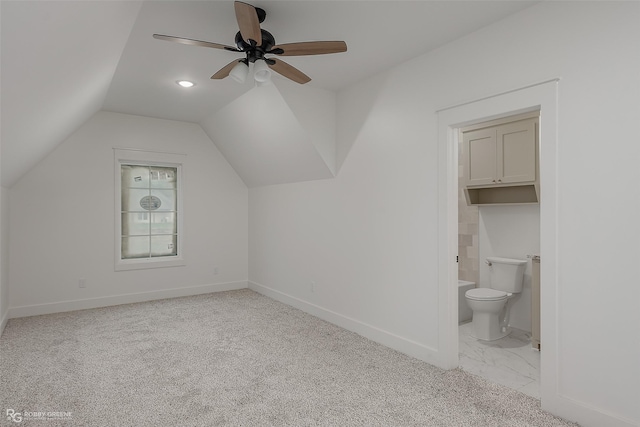 additional living space featuring ceiling fan, light colored carpet, and lofted ceiling