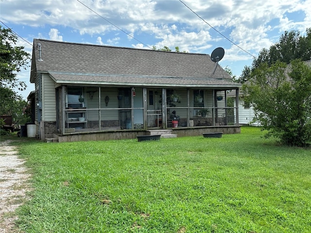 back of property featuring a yard