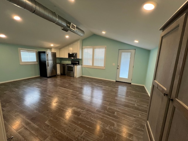 unfurnished living room featuring lofted ceiling and dark hardwood / wood-style floors