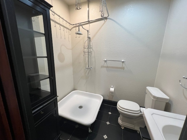 bathroom featuring vanity, toilet, and tile floors